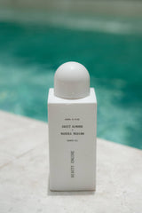 Beauty Engine Sweet Almond and Manuka Honey shower oil in a white 250ml bottle, designed to gently soften the skin.