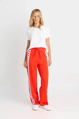 Jamie Jogger trackpants in red with white heart-patterned side stripes and a comfortable elasticated waistband.