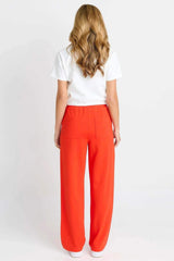 Back view of a woman wearing bright red, lightweight Jamie joggers with an elastic waistband and back pockets.