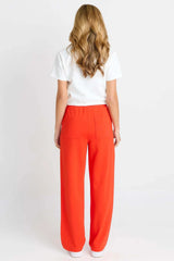 Back view of Jamie Jogger in bright orange with an elasticated waistband and functional back pockets.