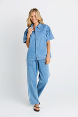 Quinn cotton shirt in light blue denim with a relaxed fit and button-through front worn with matching trousers.
