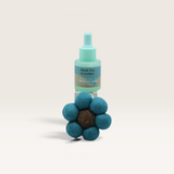 House of Holabox Bloom by Grace and James felt flower air freshener with a bottle of Black Tea & Lychee fragrance oil