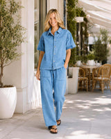 Model wearing Quinn Cotton Joggers in light blue denim with functional pockets and a relaxed fit.