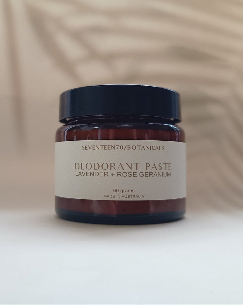 Jar of deodorant paste with a label on a neutral background