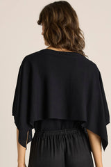 Black Kora Cape Top in a luxe lightweight knit with a soft, fluid drape worn over the shoulders.