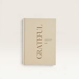 House of Holabox Myndly gratitude journal with a cream cover and gold embossed text on a white background.