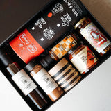 Collection of spices and seasonings in a black gift box on a white background