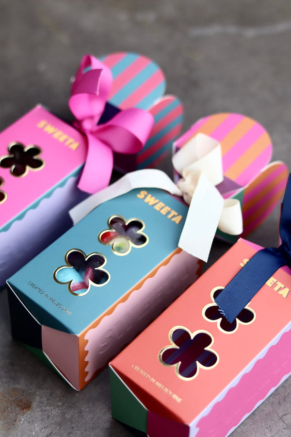 Colorful gift boxes with ribbons on a gray surface