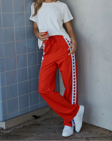 Jamie Jogger trackpants in bright red with white side stripes featuring a heart pattern and a comfortable drawstring waist.