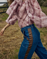 Mid-blue high-rise wide-leg denim pants featuring brown faux leather side panel detailing.