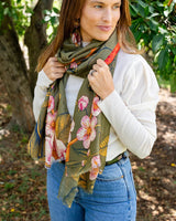 Anna Japanese Botanical scarf in moss green with vibrant red floral print, styled for autumn and winter layering.