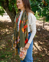 Anna Japanese Botanical scarf in moss green with vibrant red floral print, styled for autumn and winter layering.