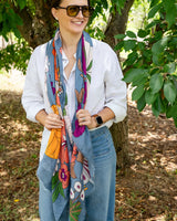Bella Botanical in Blue scarf featuring a bold, colourful floral print on a rich blue polyester blend fabric.