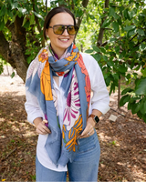 Bella Botanical in Blue scarf featuring a bold, colourful floral print on a rich blue polyester blend fabric.
