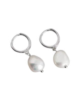 Sarah Freshwater Pearl Earrings in silver featuring small sterling silver sleeper hoops with delicate pearl drops.