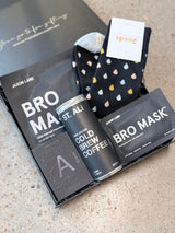 Men's self-care gift box with face mask, eye gels, cologne, cold brew coffee, socks, and Father's Day card