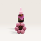 House of Holabox Bloom by Grace and James flower-shaped felt air freshener with a bottle of fragrance oil.