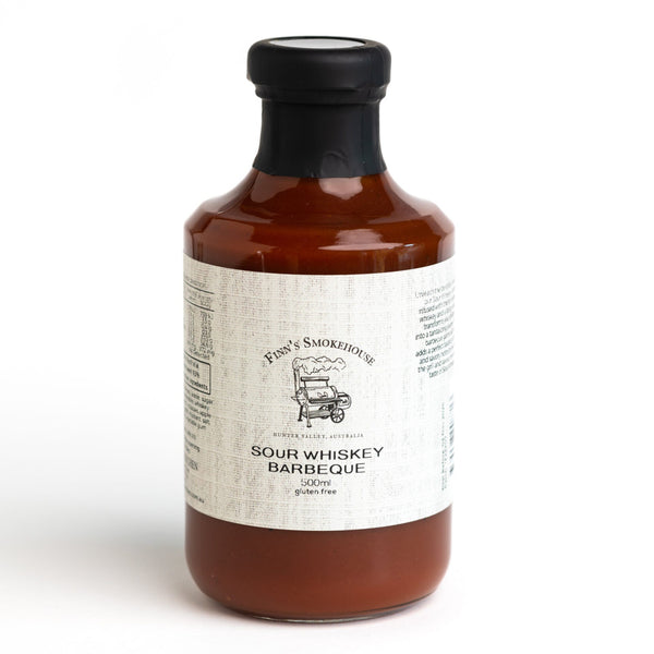Bottle of sour whiskey barbecue sauce on a white background