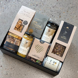 Gourmet grazing board in a box with cheese, olives, nuts, jerky, pickles, and chocolates for Father's Day gift