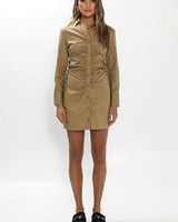Tan 100% cotton shirt dress featuring a button-down front, long sleeves, and a flattering ruched drawstring waist.