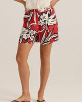 Anella short in a red, black, and white floral print with a flat front, belt loops, and side pockets.