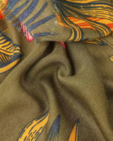 Anna Japanese Botanical scarf in moss green with vibrant floral print and frayed edges.