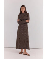 Brown midi dress with white polka dots, featuring long sleeves, a high neckline, and ruched detailing in cotton blend.