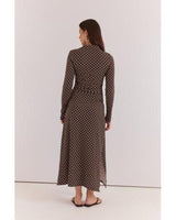 Brown long-sleeved midi dress with white polka dots, featuring a high neckline and ruched side detail.