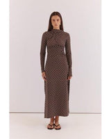 Model wearing a brown long-sleeved midi dress with white polka dots, high neckline, and side ruched detailing.