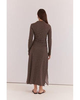 Back view of a brown midi dress with white polka dots, long sleeves, high neckline, and ruched detailing.
