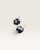 House of Holabox Aura Hoops featuring organic-shaped black and white pearl acrylic dangles on silver-plated hoops.