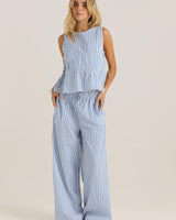Model wearing blue and white striped seersucker wide-leg pants with an elasticated self-tie waistband.
