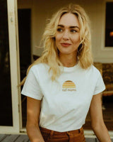 Woman wearing a natural organic cotton t-shirt with a tonal sun graphic and Rad Mama text on the chest.