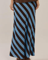 Bec Bias Skirt in a blue and brown diagonal stripe pattern, featuring a structured cotton-feel fabric.