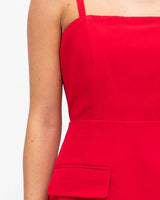 Red Becca mini dress featuring a structured boned bodice, square neckline, and tailored pocket detail.