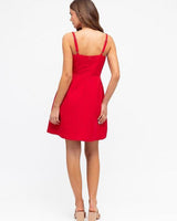 Back view of a red Becca mini dress with a boned bodice, thin straps, and a fitted silhouette on a white background.