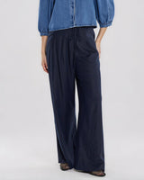 Navy tailored trousers in a viscose-linen blend, featuring a flattering wide-leg silhouette, waist darts, and a thin tie belt.