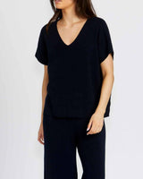 Model wearing comfortable, navy blue Bonnie pants in a soft cotton viscose blend with a relaxed, classic fit.
