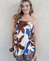 Woman wearing a strapless cotton top and matching shorts with a blue and brown tropical leaf print.