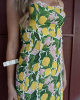 Capri maxi dress featuring a yellow lemon and pink floral print with white lace trim detailing on a cotton blend fabric.