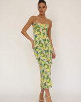 Model wearing a green and yellow lemon-print cotton-blend maxi dress with white lace trim and spaghetti straps.