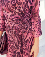 Carmel maxi dress in cerise safari animal print with a ruched waist and flowing polyester fabric.