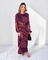 Carmel maxi dress in cerise safari animal print with long sleeves, a flowing silhouette, and cinched waist detail.