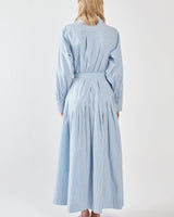 Back view of a blue and white striped shirt dress with a self-fabric tie waist and dropped pleated skirt detail.