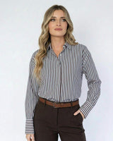 Woman wearing a relaxed-fit brown and white striped cotton shirt with a concealed placket and wide cuffs.