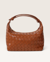 House of Holabox Cleo tan woven faux leather handbag with an adjustable top handle and textured finish.