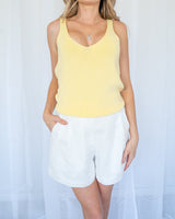 Lemon yellow sleeveless cotton knit tank top with a v-neckline and textured finish.
