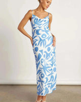 Model wearing a blue and white abstract print Corfu cowl neck cami with matching pencil skirt.