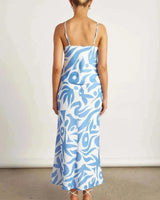 Back view of a blue and white abstract print cowl neck cami paired with a matching midi skirt.