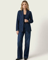 Woman wearing a dark denim Destiny blazer with a shawl collar and matching wide-leg jeans.